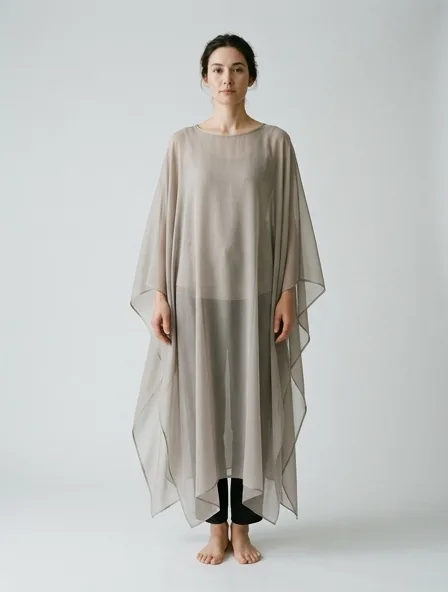 Poncho in chiffon, on a model in a studio